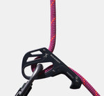 A Mammut Smart 2.0 belay device with a vibrant Mammut 9.5 Crag Dry Rope expertly threaded through it against a grey background.