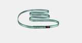 The Mammut Tubular Sling 16.0, featuring green and white stripes, is arranged in a wavy pattern on a plain white background to highlight its durable design.