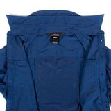 The back of a blue jacket on a white surface, with Mont Men's Lifestyle Vented Shirt anti-mosquito repellent.
