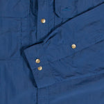A Mont men's blue shirt with gold buttons that features Bug-Off anti-mosquito repellent.